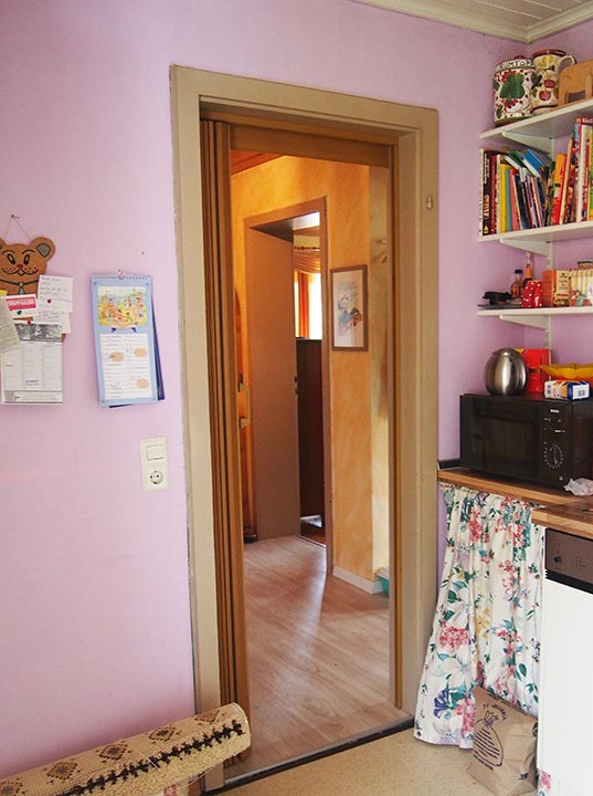 Vor der Renovierung: die Küche mit Blick in den Flur